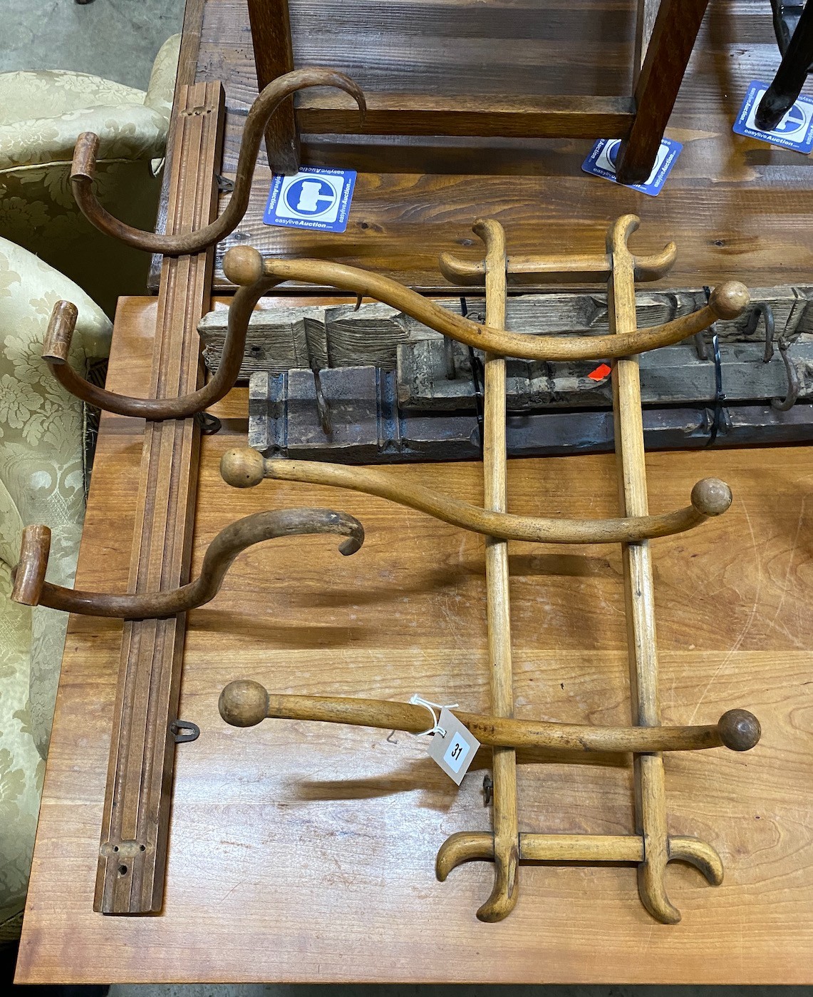 Two Bentwood coat racks together with three Eastern hardwood and wrought iron racks, largest length 156cm
